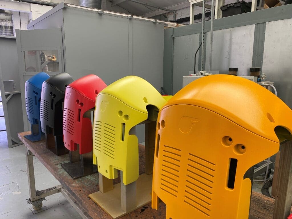 Custom-painted plastic mouldings stacked after production using durable tooling from ID Mouldings
